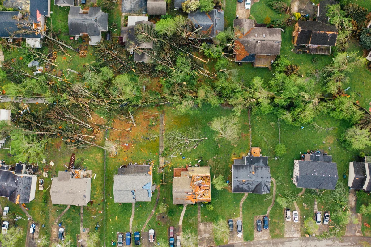 Aerial view of storm damage across a neighborhood